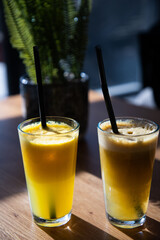 orange or apple fresh on a sunny table healthy summer refreshment