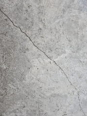 Crack on a grey concrete floor, wall, surface, grey texture