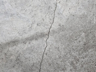 Crack on a grey concrete floor, wall, surface, grey texture
