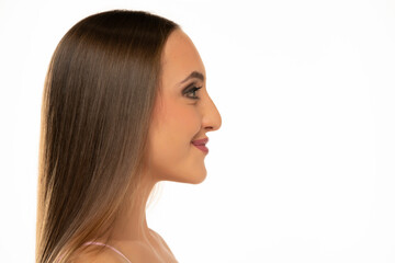 Profile face of young smiling woman on a white background