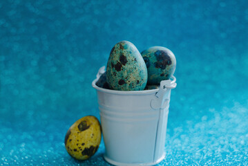 Eggs in a metal bucket on a blue background