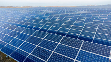 Aerial drone view flight over solar panels on sunny day close-up. Photovoltaic solar panel. Moving...