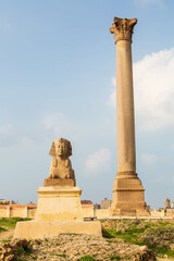 Fototapeta na wymiar Pompey's pillar and ancient sphinx statue roman triumphal column in Alexandria, Egypt