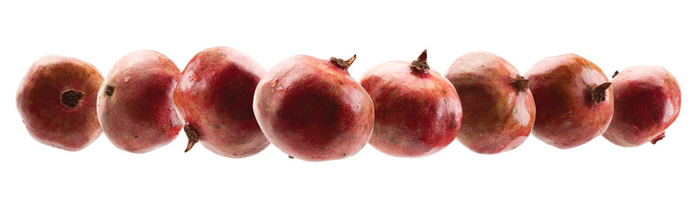 Ripe pomegranates levitate on a white background