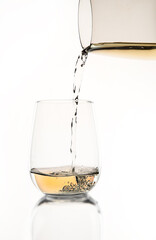 white wine or apple juice in a transparent glass isolated over white background