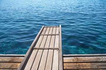 Fototapeta premium Empty wooden deck with the sea in the background.