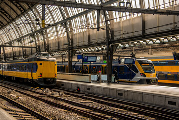 Amsterdam, Netherlands, march 2022. Dutch train in the landscape and in the central station © Bert