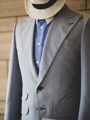 Close up of light grey suit detail with blue shirt white collar