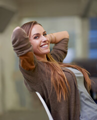Taking it easy at work. An attractive female worker having a relaxing day at the office.