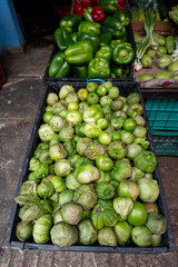 Fresh green tomatoes or tomatillo on display at a market in Mexico
