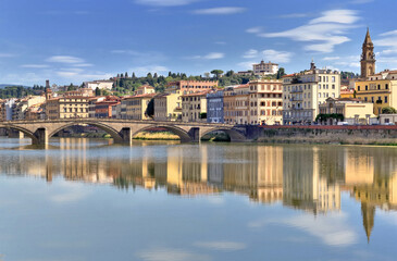 view of the city of florence in Italy from river Arno with reflection of colorful buildings on the water