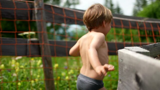 A happy child running outside wearing underwear carefree little boy