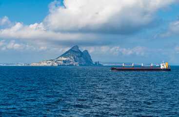 A view of a bulk carrier vessel sailing through the Straits of Gibraltar on a spring day