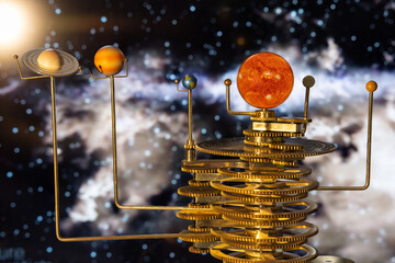 Model of the solar system made of brass close-up on a blue background