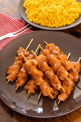 raw chicken skewer with tabbouleh in a dish on a table