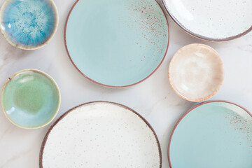 assorted ceramic plates on white marble table