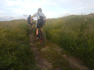 Bikers doing exercise in the meadow