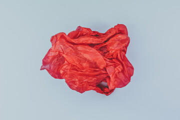 Texture of red crumpled package on a blue background