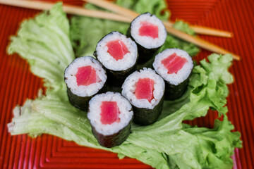 maki sushi roll with tuna on a plate with salad delivery japanese cuisine
