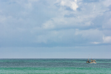 Fototapeta premium Small fishing boat at sea, Tangalle, Sri Lanka