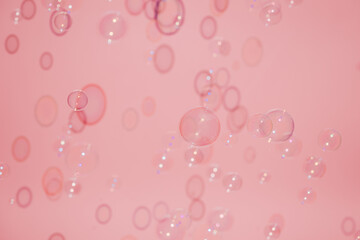 Soap bubble pattern in front of the pink background.