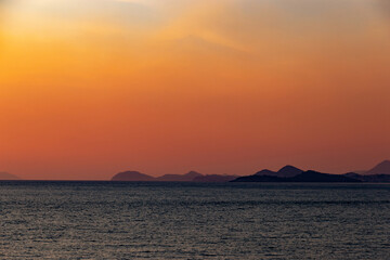 Obraz na płótnie Canvas Orange sunset over a sea