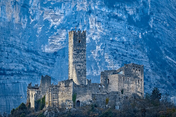 The medieval ruin of Drena castle stands out against the rocky walls of Casale Mount. Drena, Laghi...