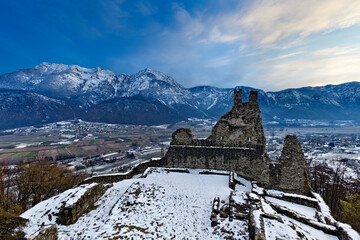 The crenellated ruins of Selva Castle and mount Cima Vezzena in winter. Levico Terme, Trento province, Trentino Alto-Adige, Italy, Europe.