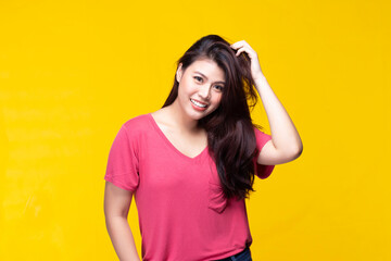 Image of feeling smile and happy. Cheerful young asian woman with brunette long hair in casual shirt smiling with teeth on yellow background. Female face expressions and emotions concept.