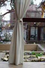 Patio construction decoration with curtains. Outdoor architecture and design. Open patio interior.