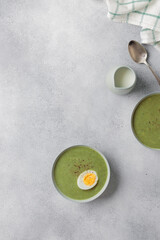 Spinach cream soup with boiled egg top view