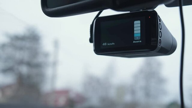 The DVR works in the car. Video recording of the traffic situation while driving. The car is moving along a busy highway