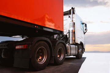Naklejka na ściany i meble Semi Trailer Trucks Parked with Sunset Sky. Shipping Trucks. Engine Diesel Truck. Lorry. Industry Freight Trucks Logistics Cargo Transport. 