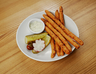 fried cheese sticks with sauce and cucumber