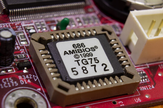Sochi, Russia - March 22 2022: AMIBIOS BIOS chip in a socket on a personal computer motherboard. BIOS is an old computer boot technology. Outdated equipment. Software vulnerability in old hardware.