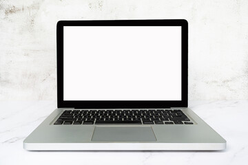 Laptop or notebook with blank screen on white table. Copy space.