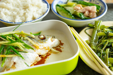 angle view fast food of steamed fish and water spinach and pork with cucumber and rice at horizontal composition