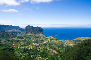 Fototapeta na wymiar Miradouro da Portela, view of Penha de agua mountain and eagle rock and Porto Da Cruz, Madeira island