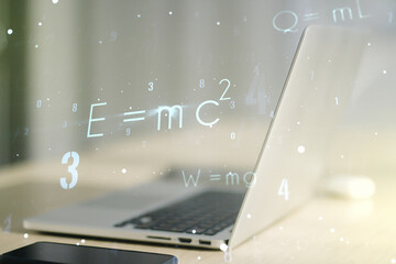 Double exposure of creative scientific formula concept on laptop background, research and...