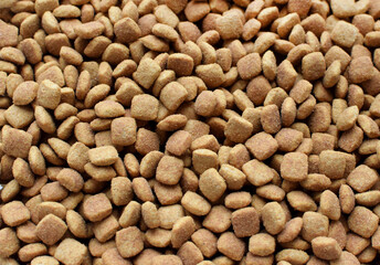 Background of dry pet food. Complete nutrition in granules for dogs and cats