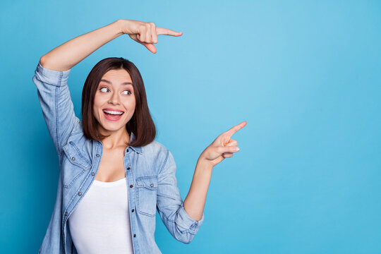 Portrait of positive person look direct two fingers empty space offer novelty isolated on blue color background