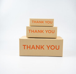 Three closed cardboard boxes taped up, and there is a Thank you for being our customer beside the parcel box for delivery and shopping online concept design isolated on white background.