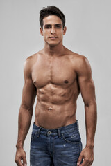 Hes got the perfect body. A handsome young shirtless man posing in studio.