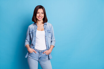 Photo of charming shiny woman wear jeans shirt smiling empty space isolated blue color background