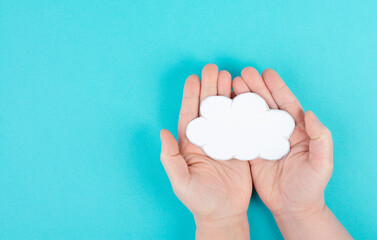 Holding a white cloud in the hand, empty copy space for text, blue  background, communication and marketing concept, being connected, networking