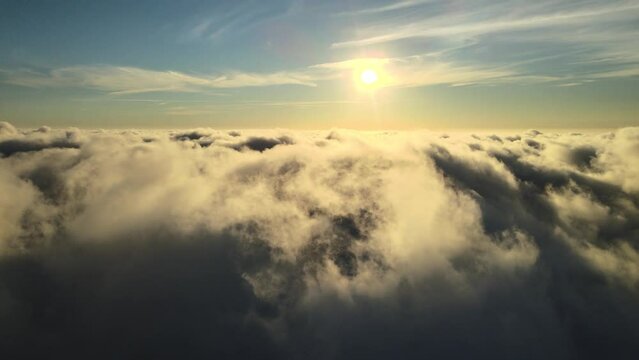 Fabulous flight over the clouds at sunset. above the sky. Sunset above the clouds. Dense clouds.