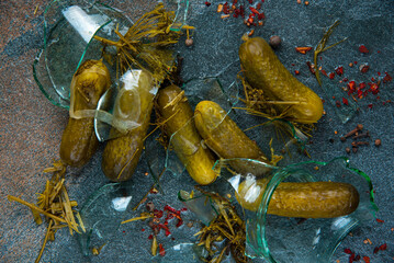 Pickled cucumbers in a broken jar