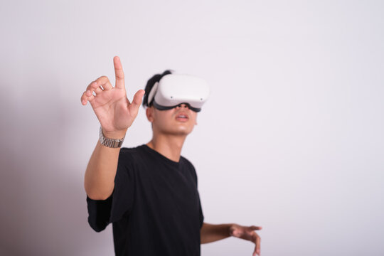 Surprised teen male student use vr glasses and looks at empty copy space .Virtual gadgets for entertainment, work, free time and study. Virtual reality metaverse technology concept.