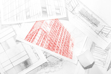 Background on the theme of construction and real estate insurance with lying architectural drawings. Sheets with sketches of modern buildings.
