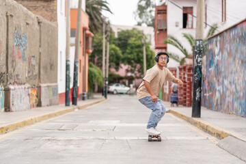 Ethnic teenager riding skateboard on street